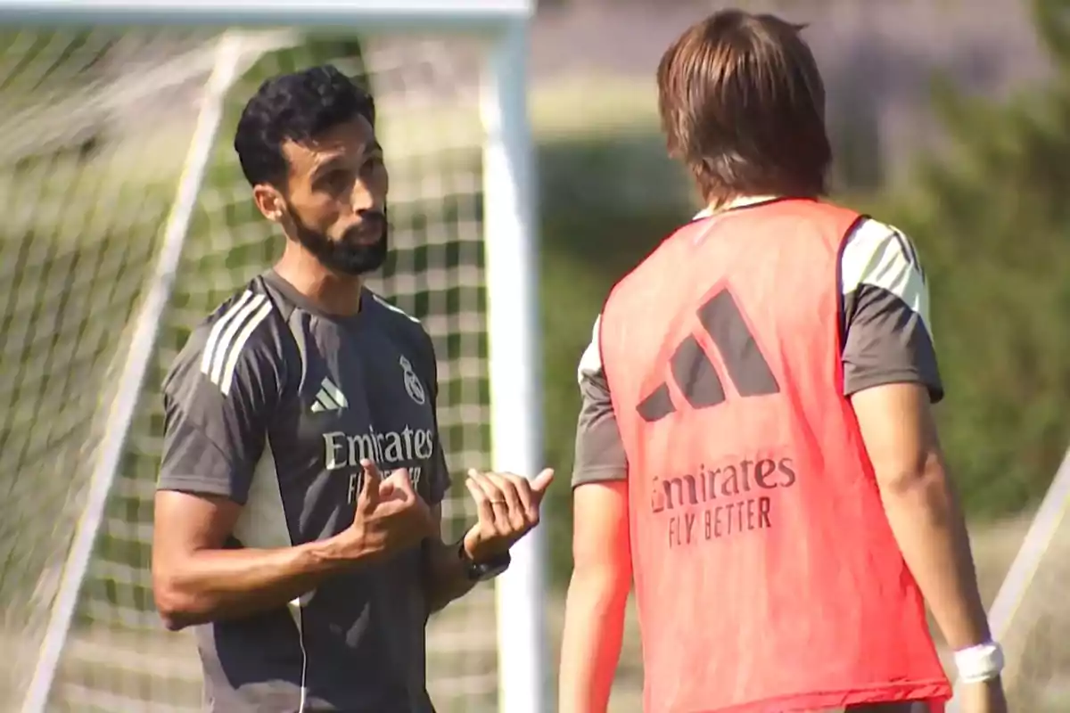 Soccer coach talking to a player during a practice on the field Soccer coach talking to a player during a practice on the field