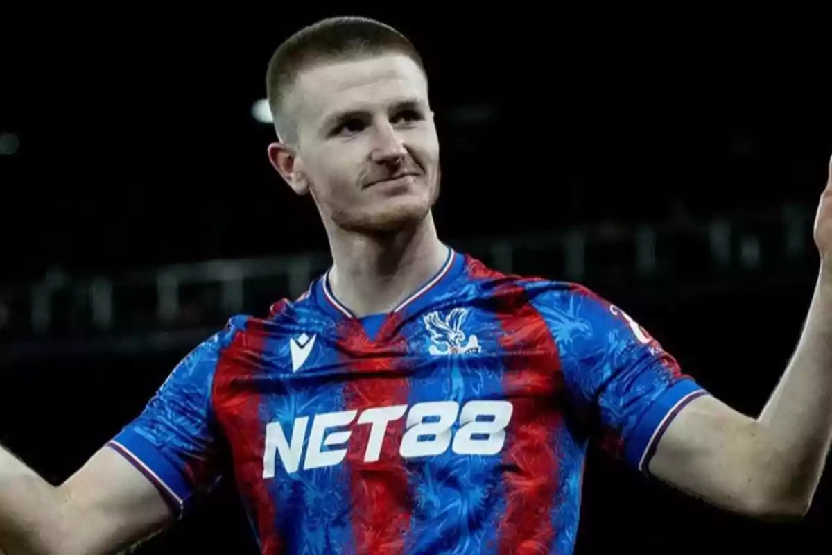 Soccer player in a blue and red uniform celebrating in a stadium Soccer player in a blue and red uniform celebrating in a stadium
