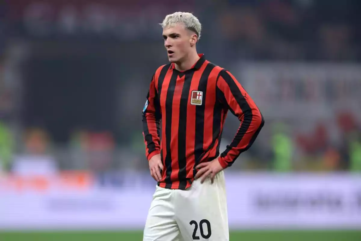 Soccer player with blond hair and a red and black striped uniform with the number 20 on the shorts during a match Soccer player with blond hair and a red and black striped uniform with the number 20 on the shorts during a match