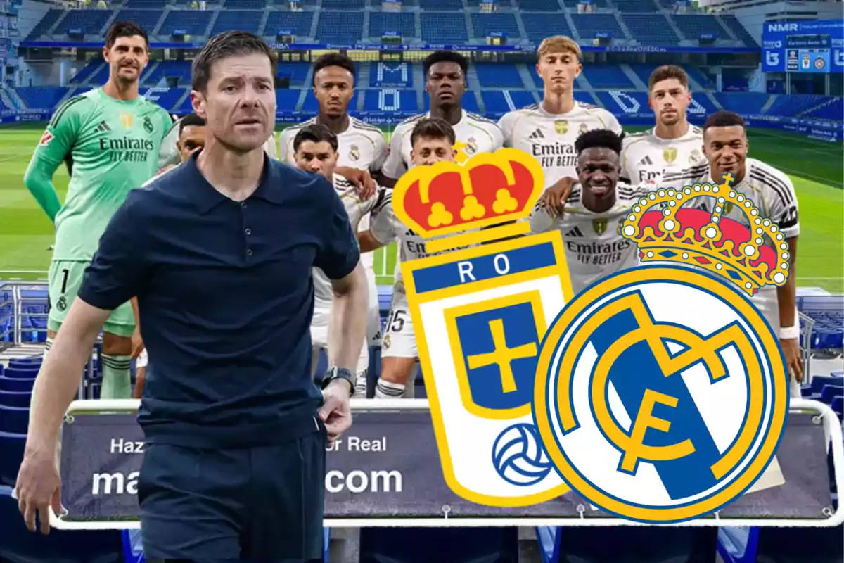 Un entrenador de fútbol al frente de un grupo de jugadores con uniformes del Real Madrid en un estadio, junto a los escudos de Real Oviedo y Real Madrid.