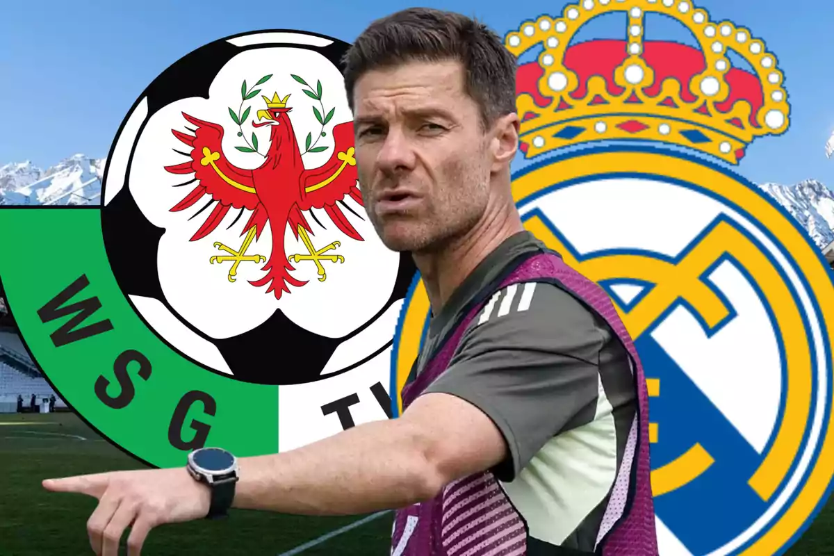 Soccer coach pointing with WSG Tirol and Real Madrid logos in the background at a stadium with snow-capped mountains