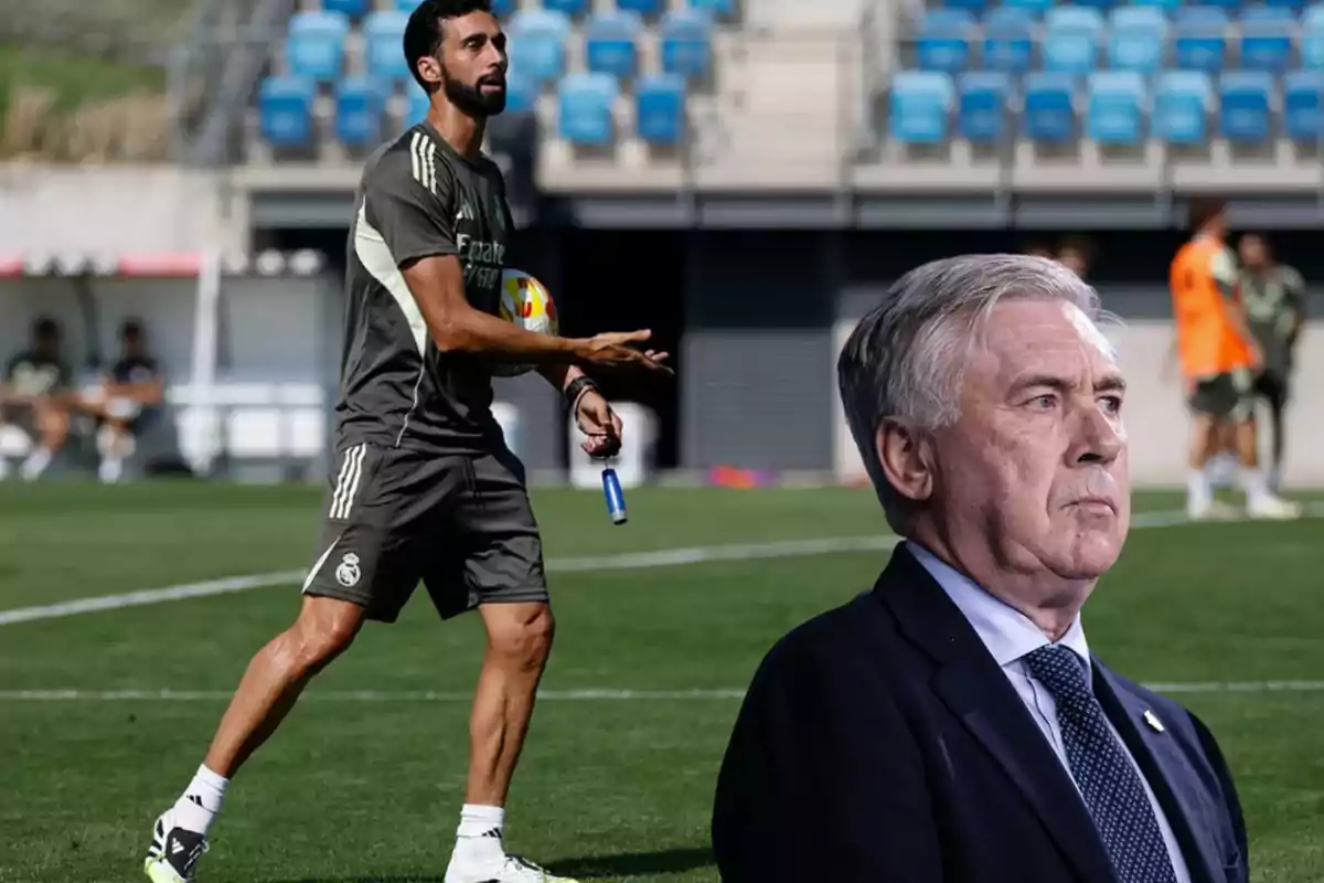 Entrenador de fútbol en el campo con uniforme deportivo y un hombre de traje en primer plano sobre el césped de un estadio