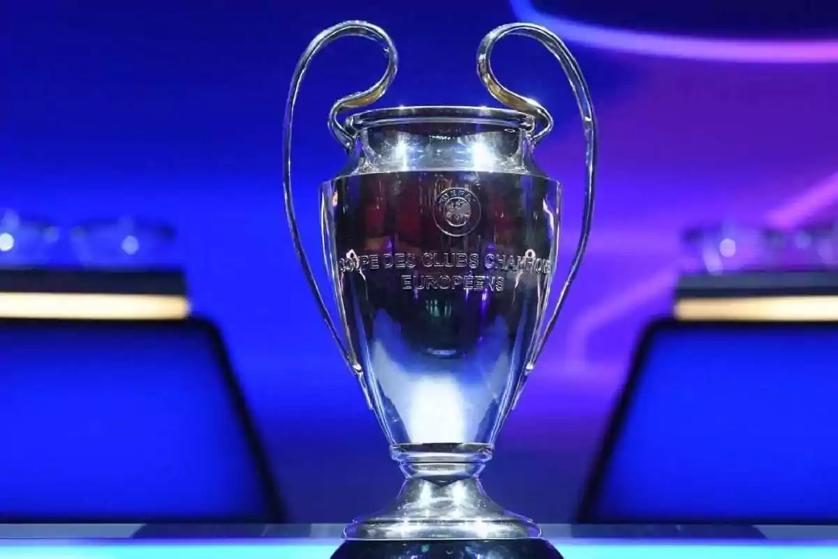 Champions League trophy on a table with a lit blue background