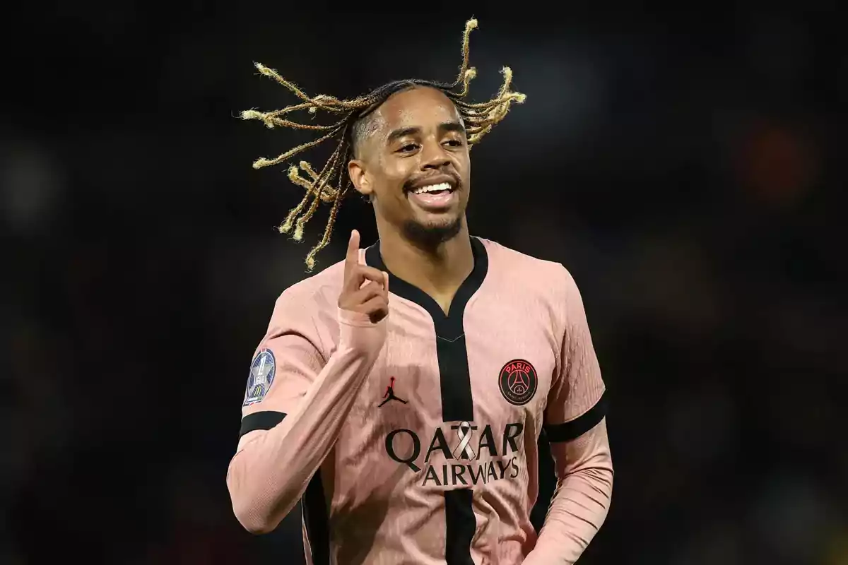 PSG player celebrating on the field wearing the pink and black uniform PSG player celebrating on the field wearing the pink and black uniform