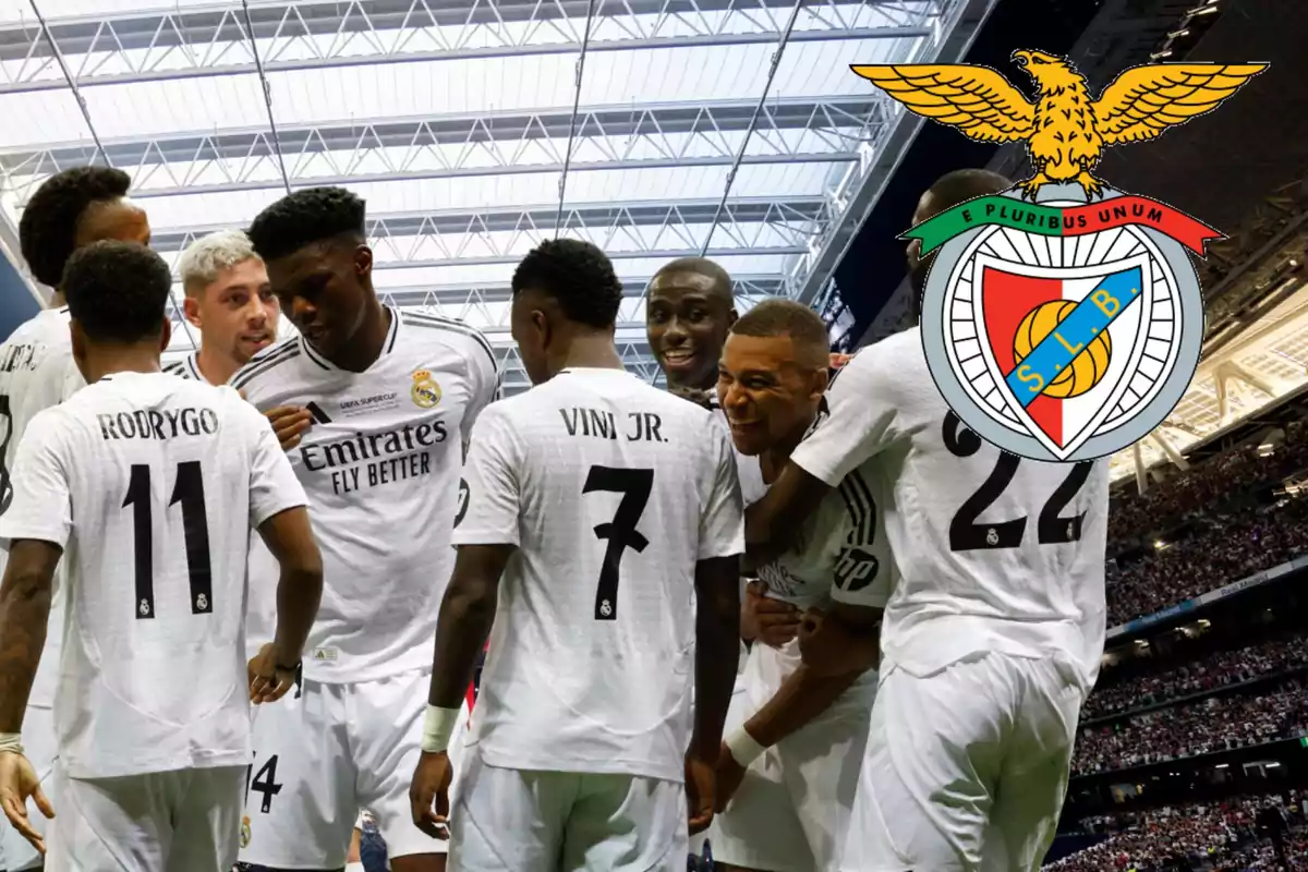 Real Madrid players celebrate a goal in an indoor stadium while Benfica’s crest appears above one of them.