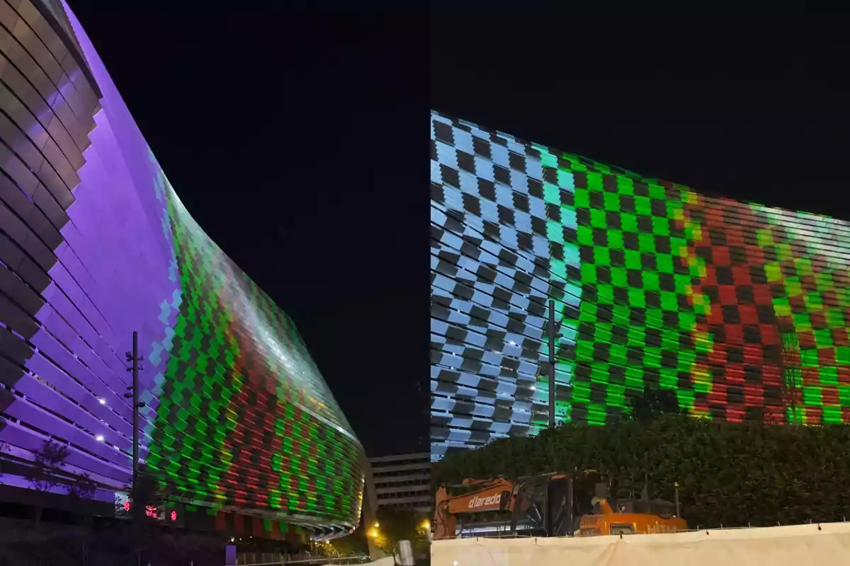 Facade of a modern building illuminated at night with colored patterns in shades of purple, green, and red