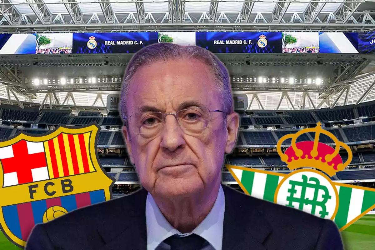 A man with a serious expression in a soccer stadium with the Barcelona and Betis crests on either side.