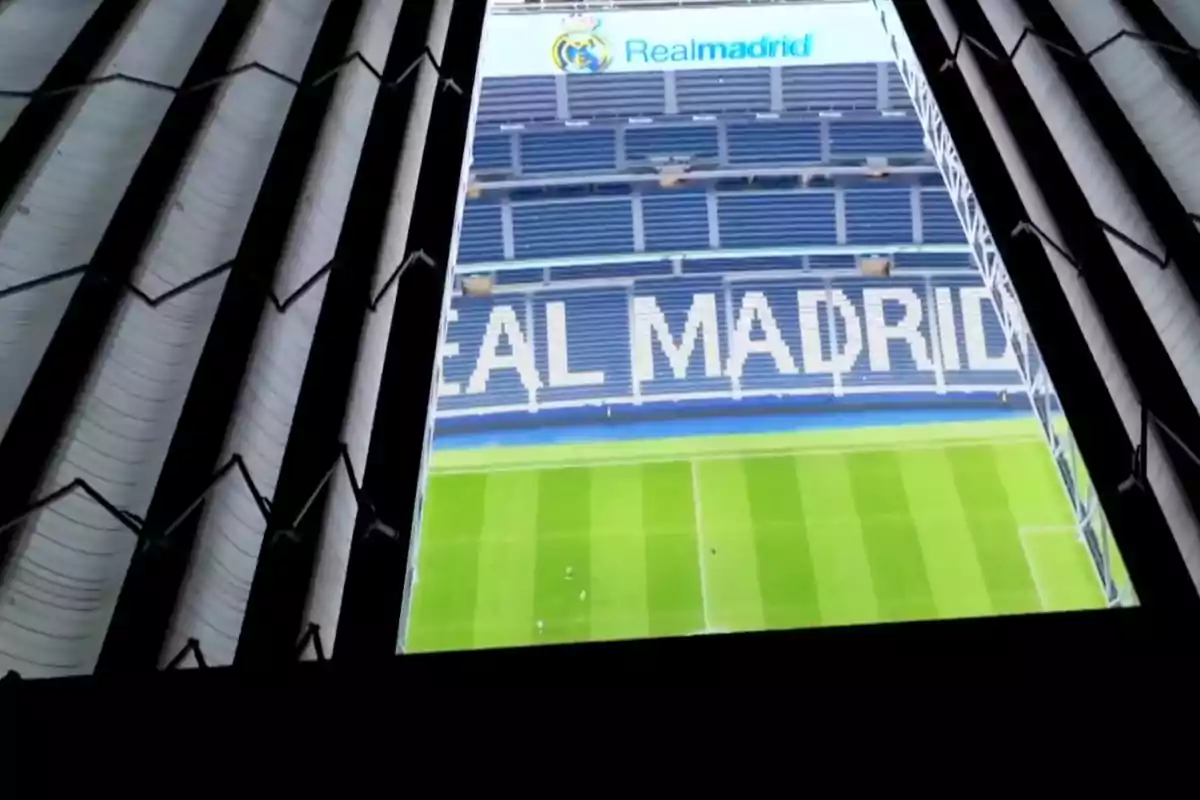 View of the interior of Santiago Bernabéu Stadium with the field and stands displaying the name Real Madrid View of the interior of Santiago Bernabéu Stadium with the field and stands displaying the name Real Madrid