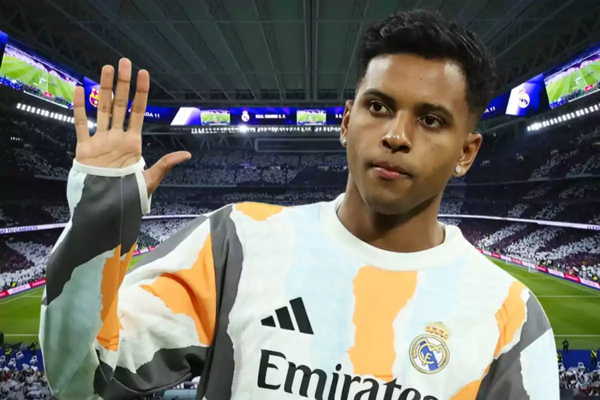 Real Madrid player wearing a training jersey waves to the crowd in a stadium full of fans