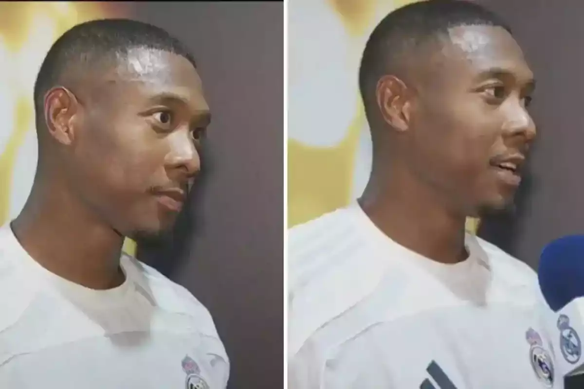 Man wearing a white Real Madrid jersey being interviewed in front of a dark background