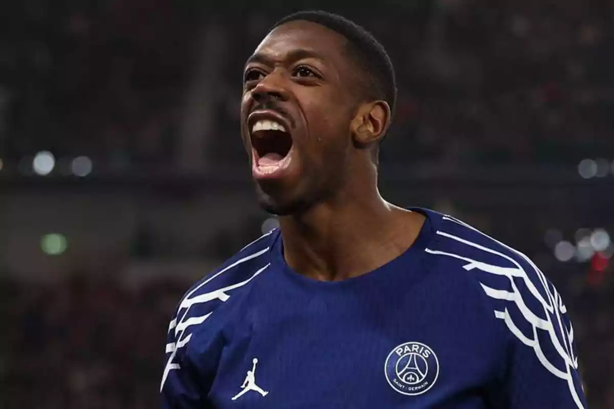 Soccer player in a blue PSG jersey celebrating enthusiastically in a stadium Soccer player in a blue PSG jersey celebrating enthusiastically in a stadium