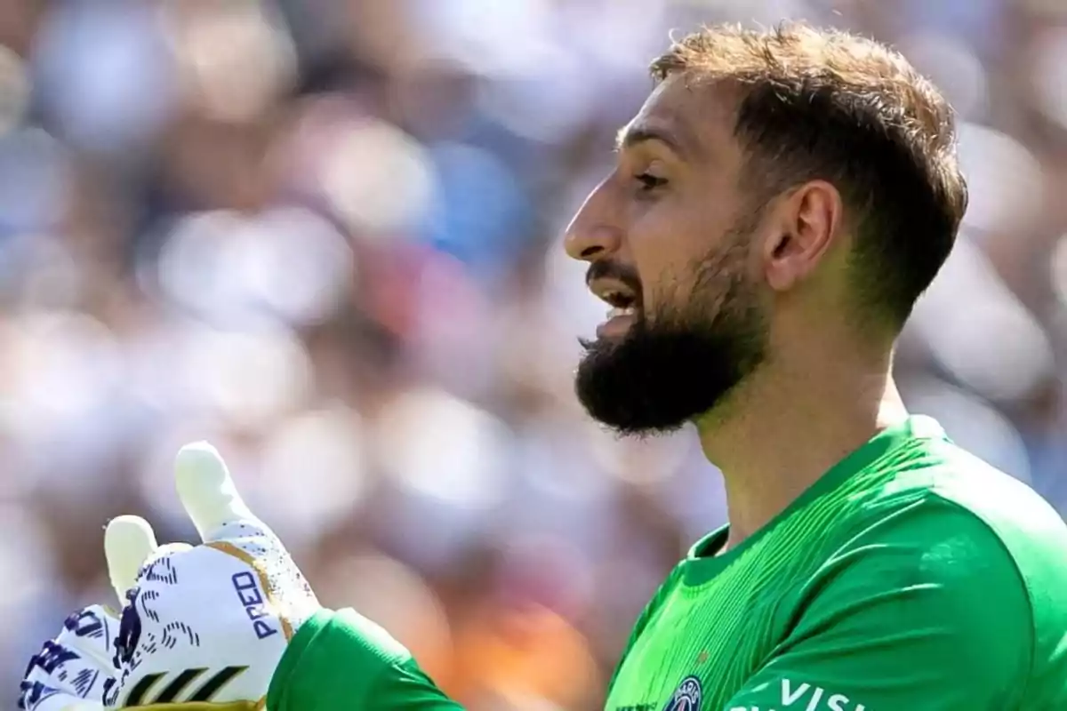 Soccer goalkeeper wearing gloves and a green uniform gesturing during a match Soccer goalkeeper wearing gloves and a green uniform gesturing during a match