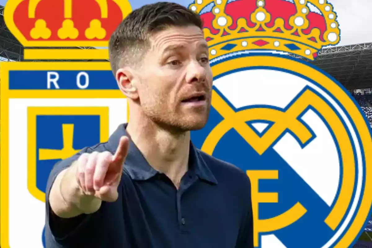 Un hombre con barba y camiseta azul señala con el dedo mientras al fondo aparecen los escudos de Real Oviedo y Real Madrid.