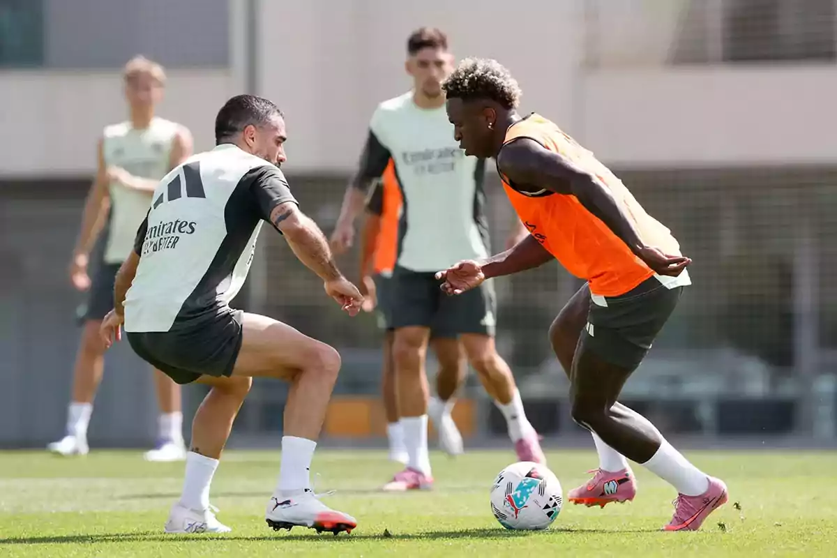 Soccer players training on a field while contesting the ball Soccer players training on a field while contesting the ball