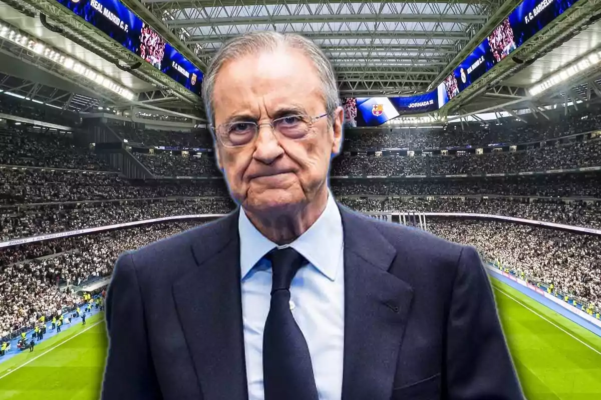 Man in a suit and tie in a football stadium full of fans