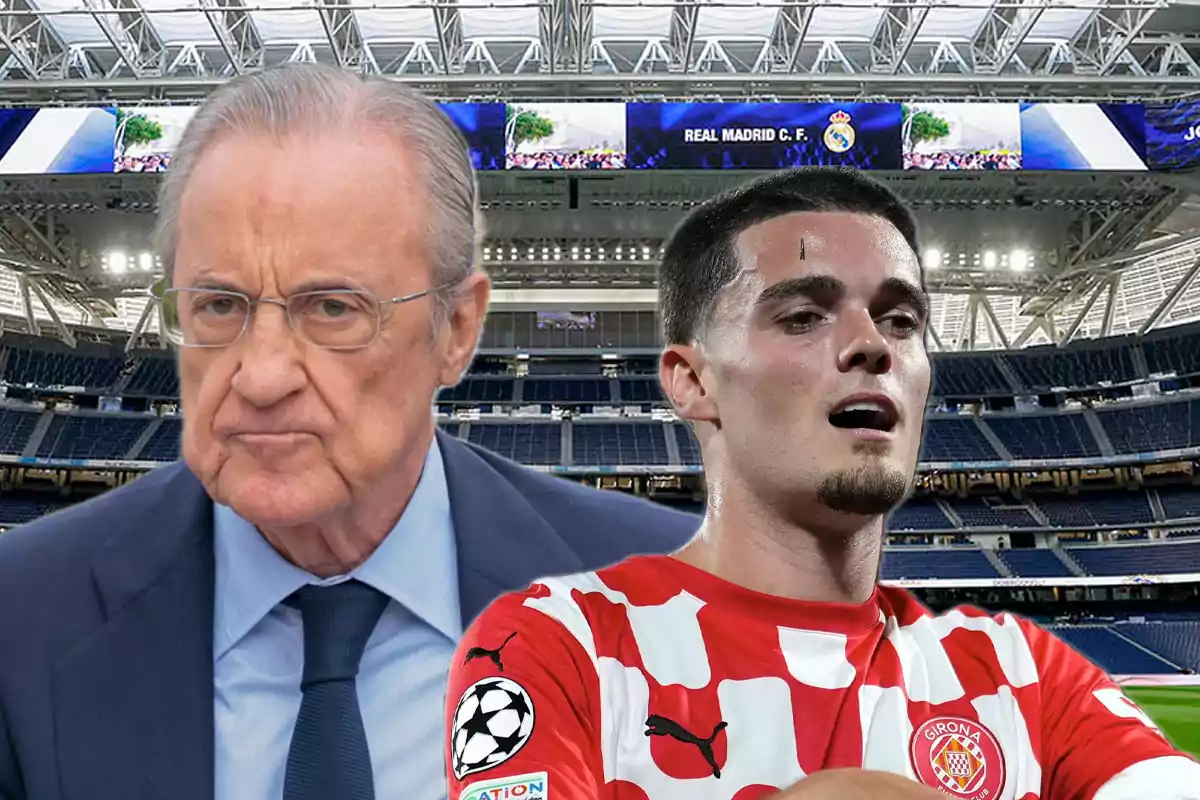 An older man with glasses and a serious expression next to a player in a red and white uniform inside a modern soccer stadium with empty stands and a Real Madrid sign in the background.