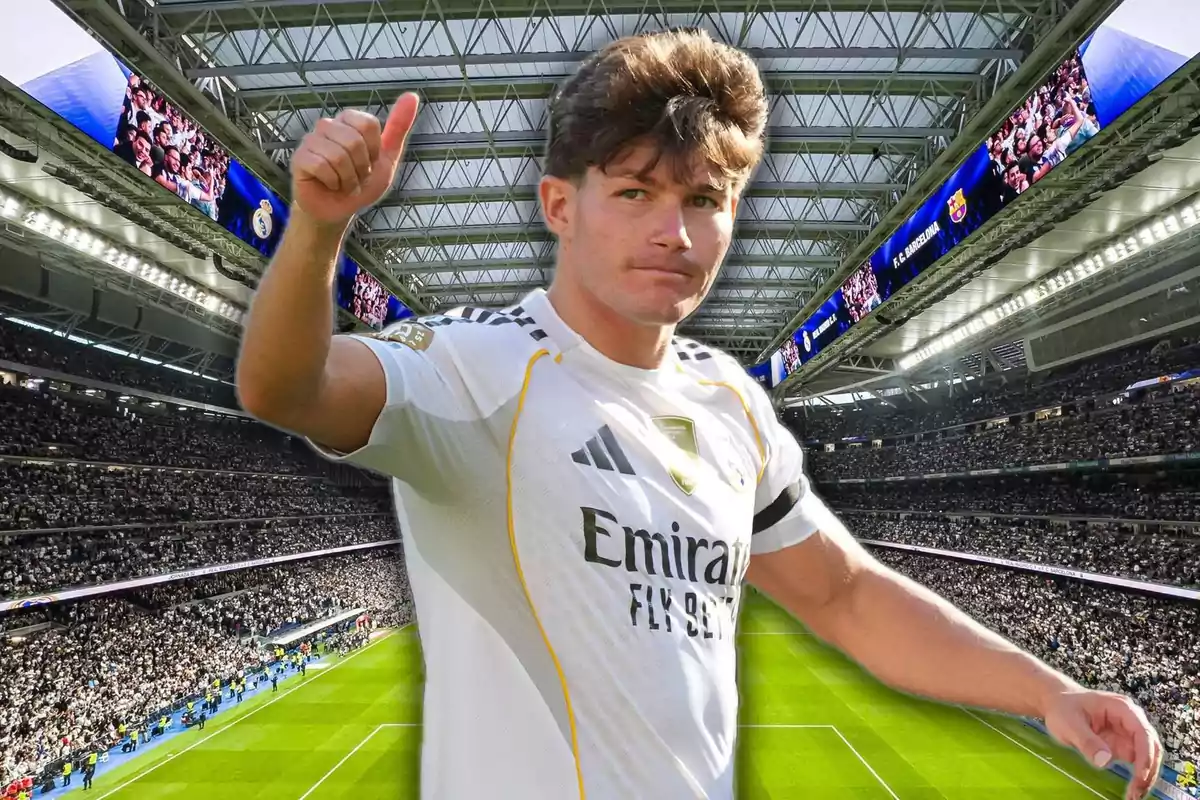 Jugador de fútbol con uniforme blanco de Real Madrid levantando el pulgar en señal de aprobación dentro de un estadio lleno de aficionados