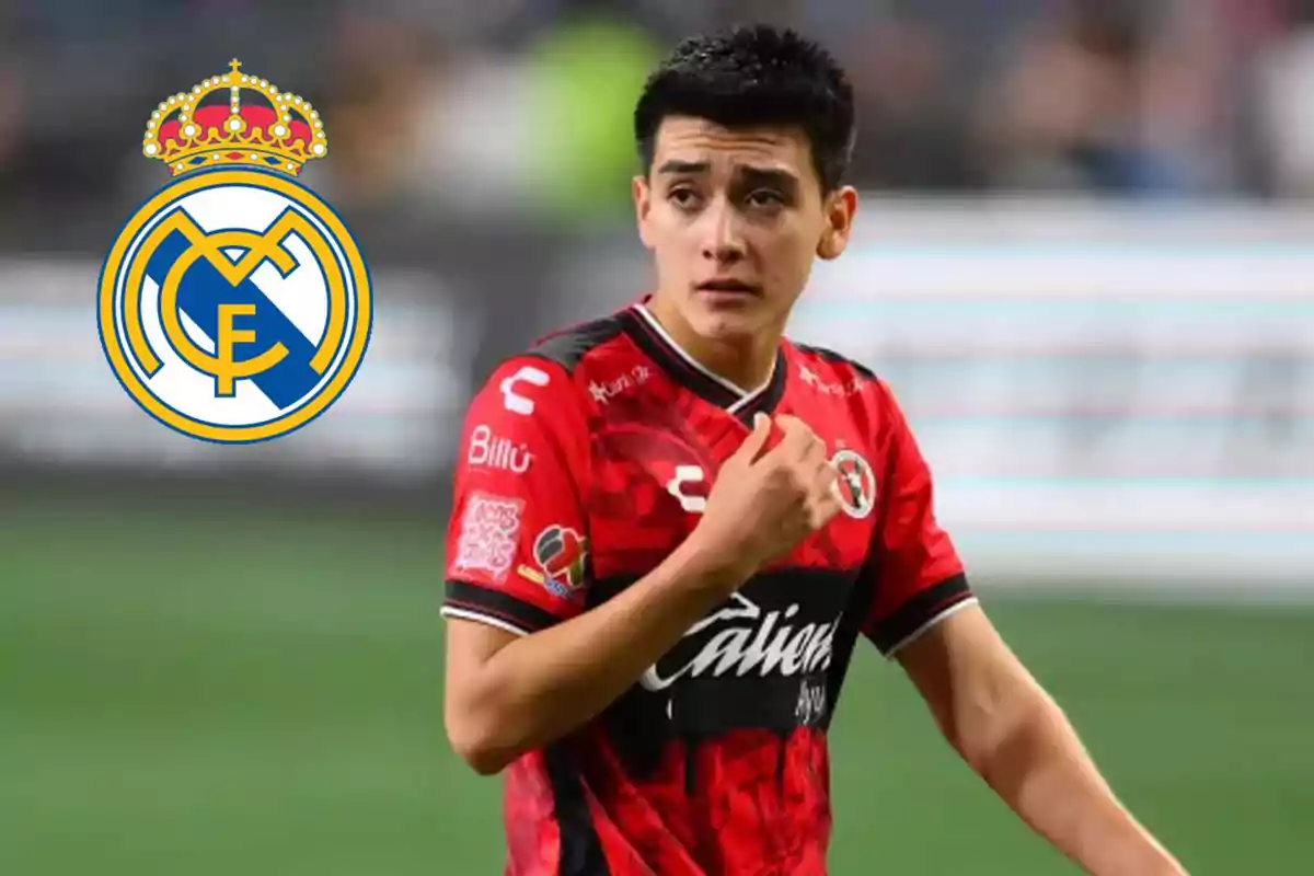 Soccer player in a red Xolos uniform on the field with the Real Madrid crest in the background Soccer player in a red Xolos uniform on the field with the Real Madrid crest in the background