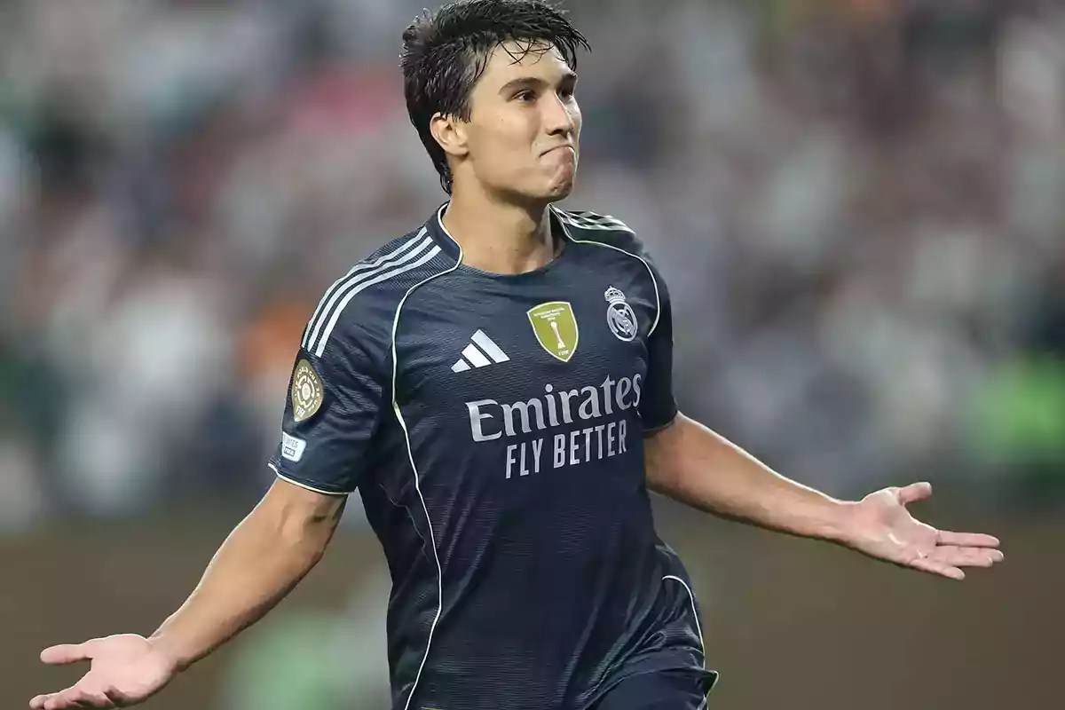 Real Madrid player celebrating a goal with arms outstretched and a look of satisfaction on his face during a match Real Madrid player celebrating a goal with arms outstretched and a look of satisfaction on his face during a match