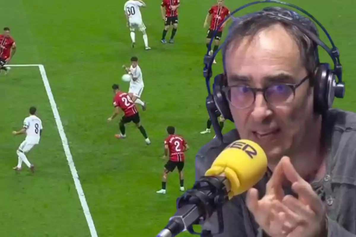 A sports commentator wearing headphones and a microphone appears in the foreground, while in the background a soccer play is taking place with several players contesting the ball inside the penalty area.