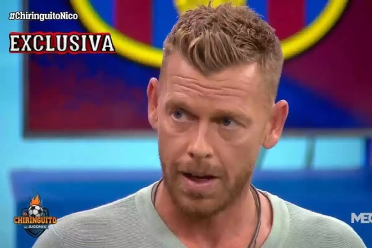 Blond man with a beard speaking on a sports TV show with the word exclusive on the screen