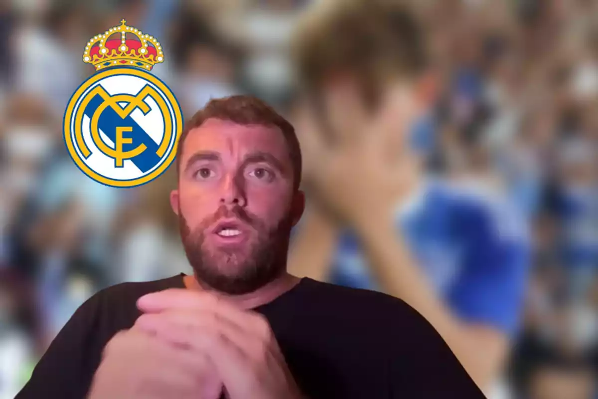 Hombre con barba al frente de un fondo borroso con el escudo del Real Madrid a la izquierda