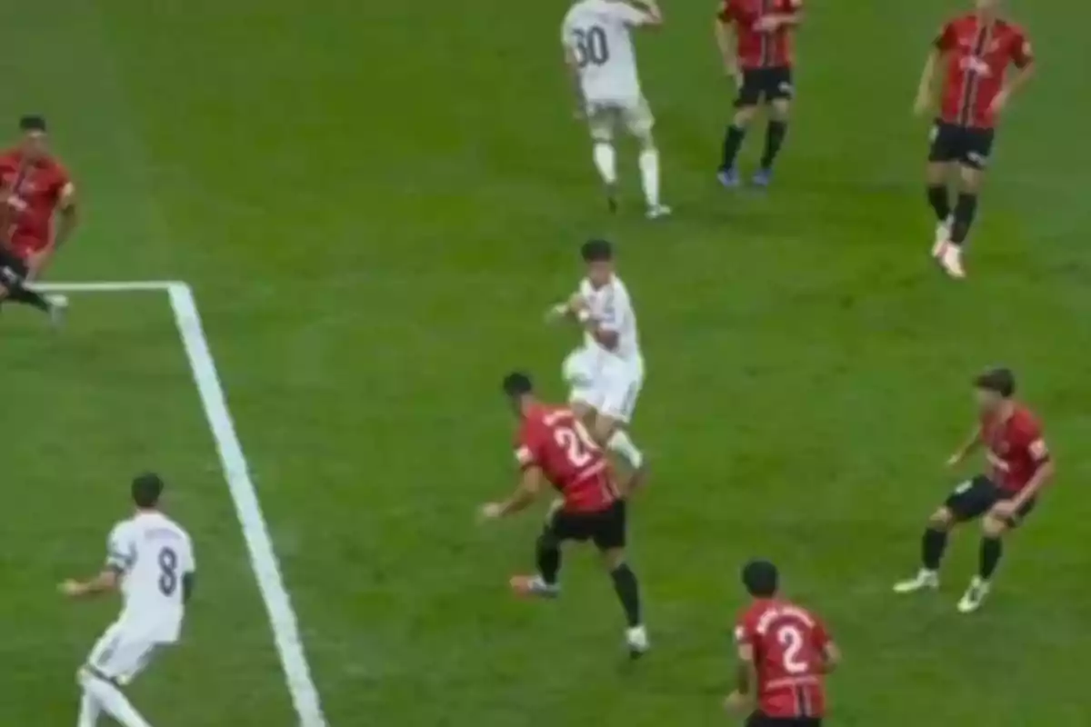 Players from two soccer teams contest the ball inside the box during a match. Players from two soccer teams contest the ball inside the box during a match.