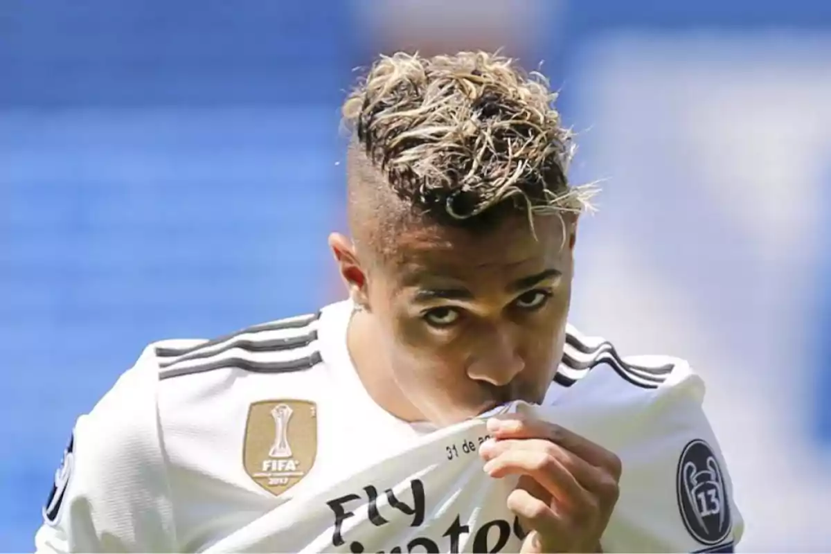 Futbolista besando el escudo de la camiseta del Real Madrid en un estadio Futbolista besando el escudo de la camiseta del Real Madrid en un estadio