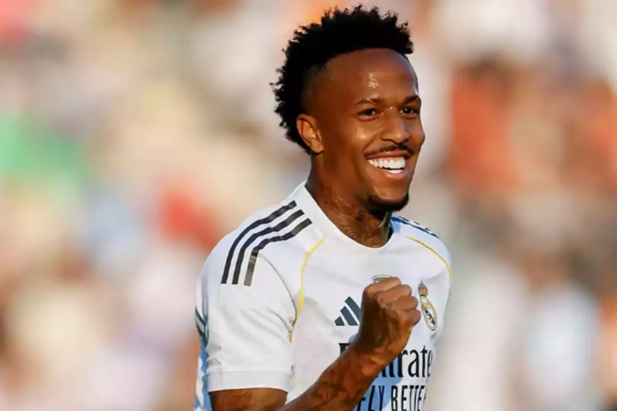 Soccer player in a white Real Madrid uniform celebrating on the field with a big smile Soccer player in a white Real Madrid uniform celebrating on the field with a big smile
