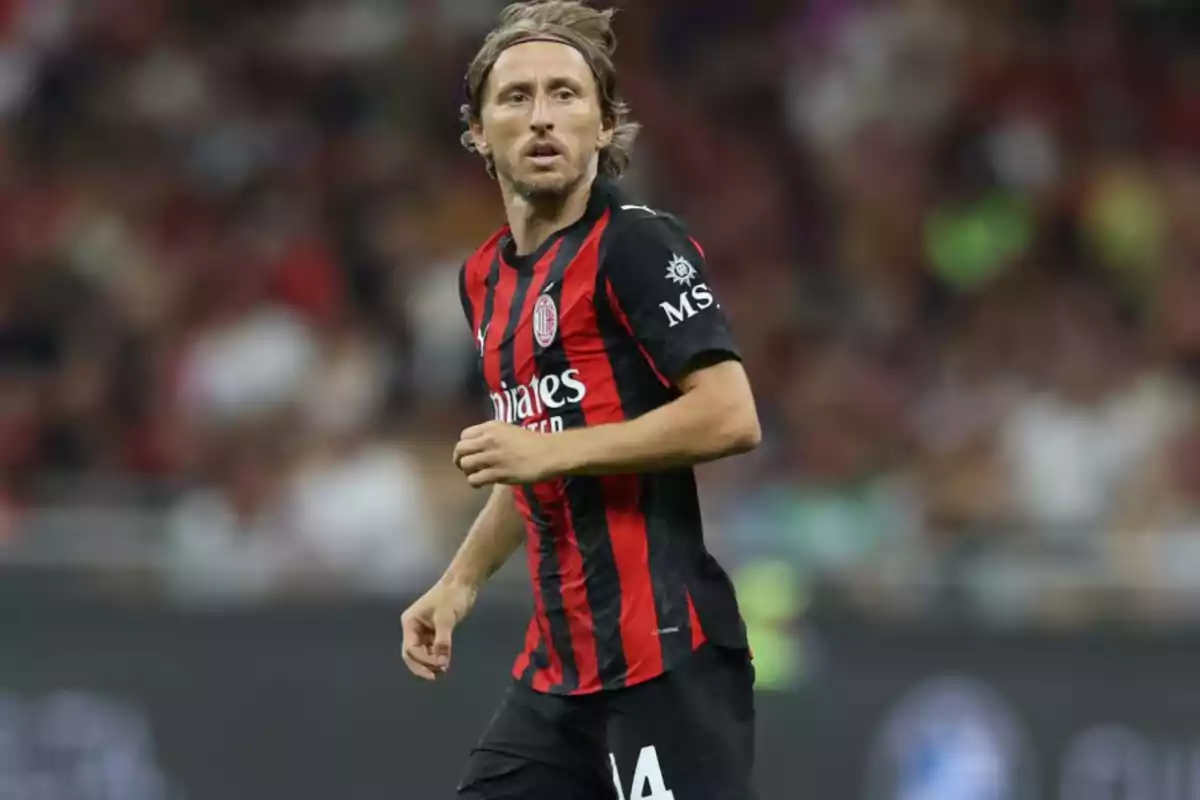 Soccer player in a black and red uniform in a soccer match Soccer player in a black and red uniform in a soccer match