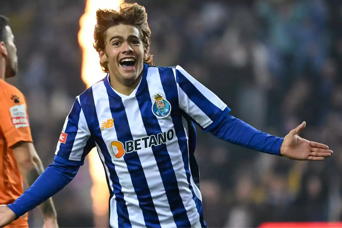 Soccer player in a blue and white striped uniform celebrating in a stadium Soccer player in a blue and white striped uniform celebrating in a stadium