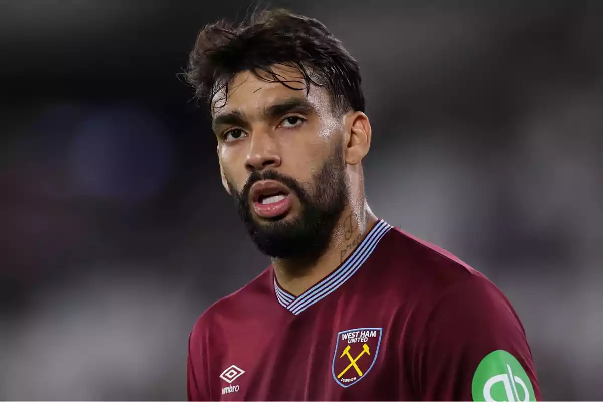 Soccer player with a beard and dark hair wearing the West Ham United uniform during a match Soccer player with a beard and dark hair wearing the West Ham United uniform during a match