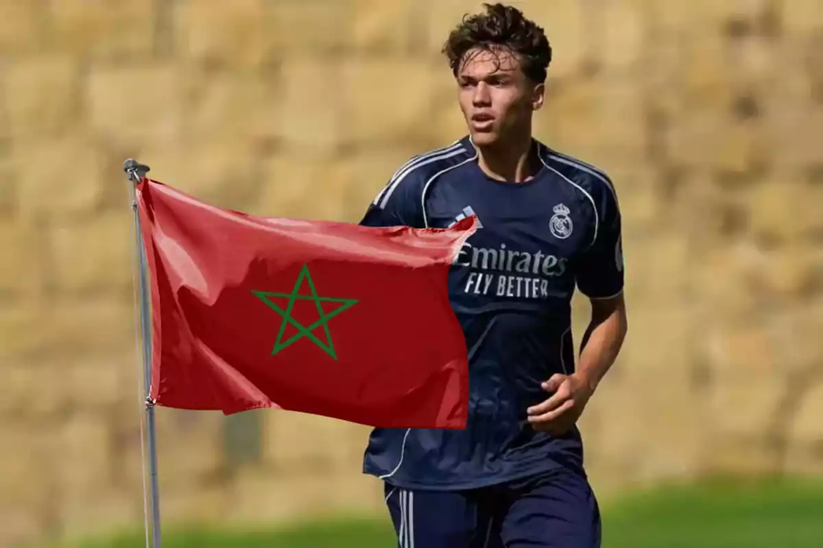 Soccer player in a dark blue Real Madrid uniform next to a waving Moroccan flag