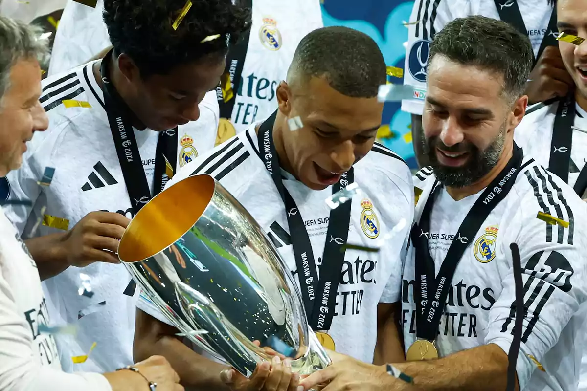 Real Madrid players celebrate with a trophy as golden confetti falls.