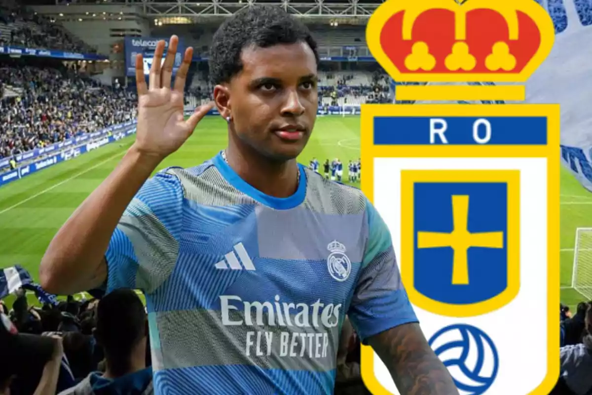 Un futbolista con la camiseta del Real Madrid saluda en un estadio con el escudo del Real Oviedo de fondo