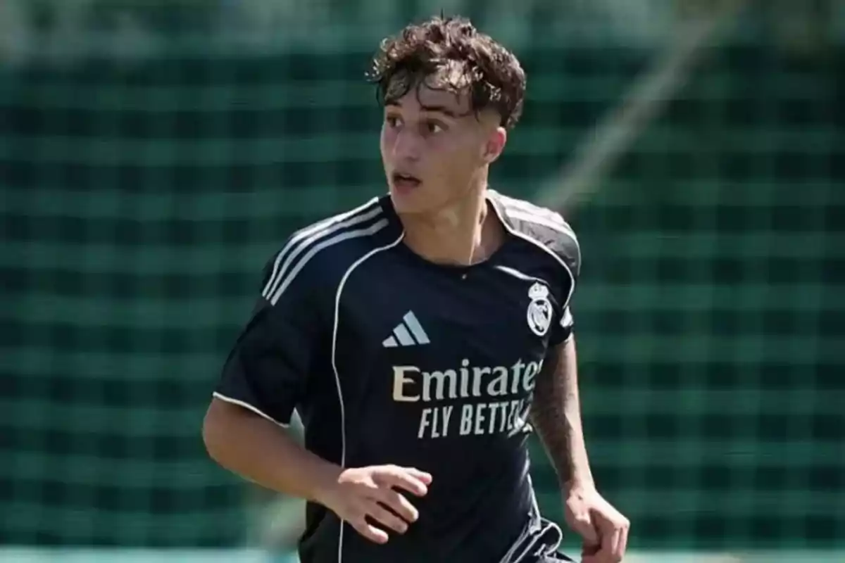 Soccer player in a dark Real Madrid uniform in action during a match. Soccer player in a dark Real Madrid uniform in action during a match.