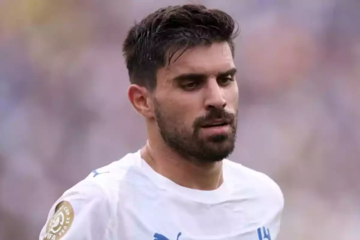 Soccer player wearing a white jersey during a match Soccer player wearing a white jersey during a match