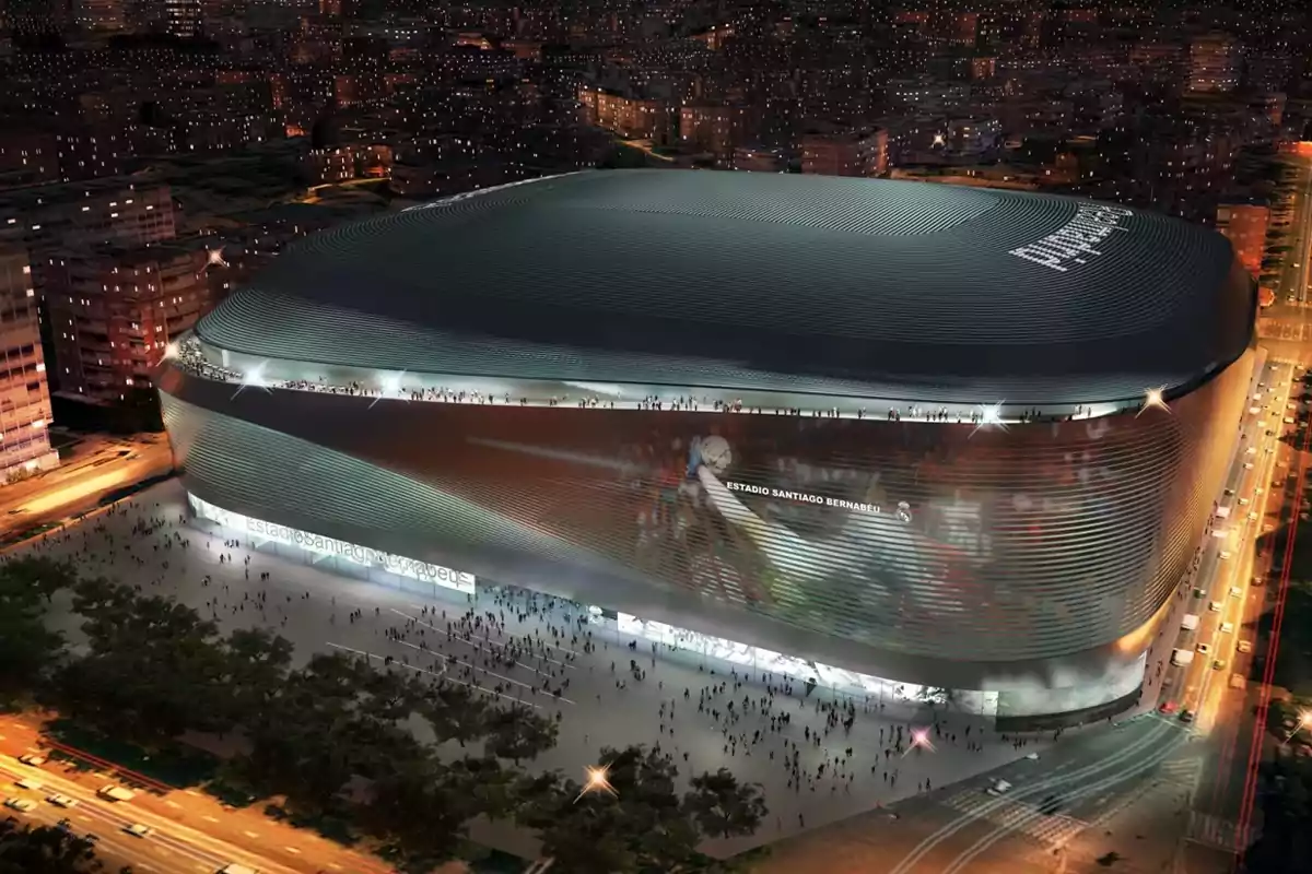 Night view of Santiago Bernabéu Stadium illuminated and surrounded by people and traffic in the city Night view of Santiago Bernabéu Stadium illuminated and surrounded by people and traffic in the city