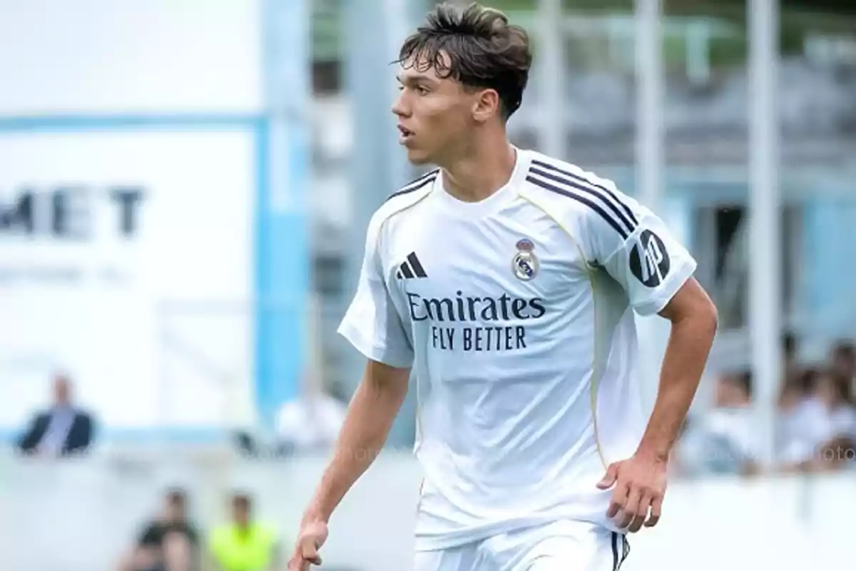 Soccer player wearing Real Madrid’s white uniform in a match Soccer player wearing Real Madrid’s white uniform in a match