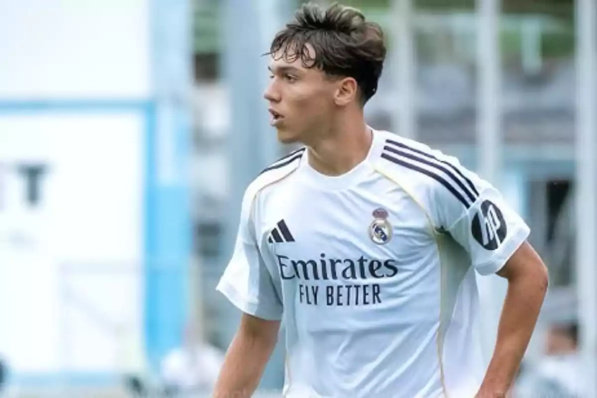 Soccer player in a white Real Madrid uniform during a match Soccer player in a white Real Madrid uniform during a match