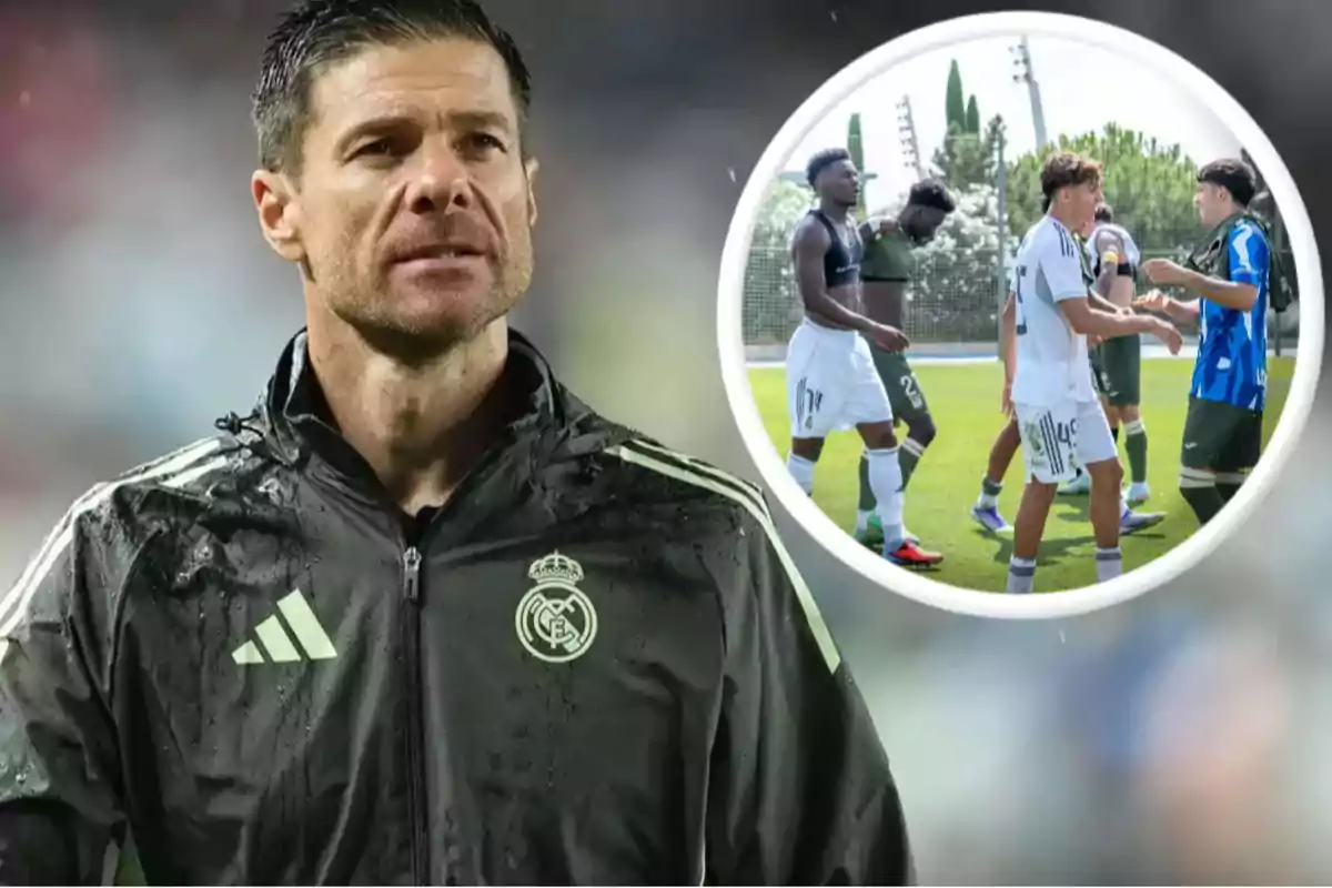 Real Madrid coach in a black jacket and players greeting each other on a soccer field in the background