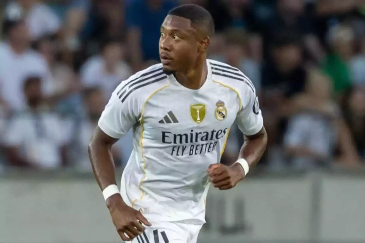 Soccer player in a white Real Madrid uniform running on the field during a match Soccer player in a white Real Madrid uniform running on the field during a match