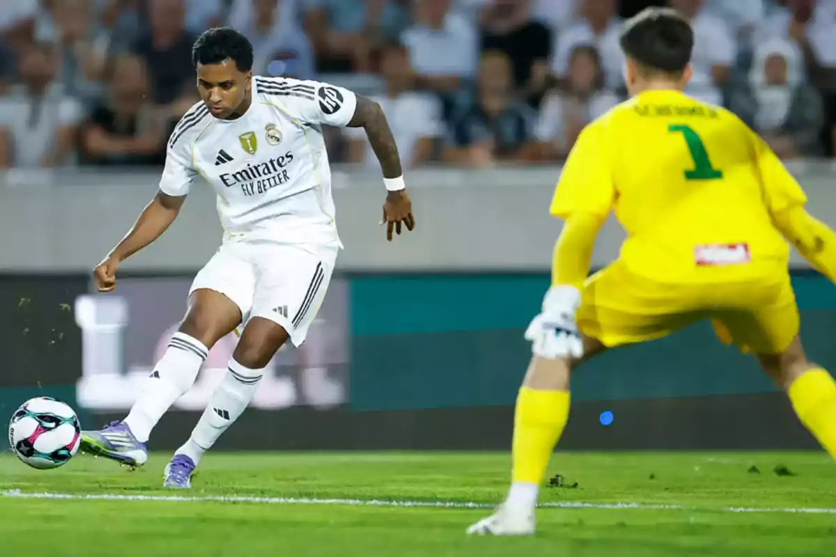 Real Madrid player about to shoot the ball in front of a goalkeeper dressed in yellow during a soccer match Real Madrid player about to shoot the ball in front of a goalkeeper dressed in yellow during a soccer match