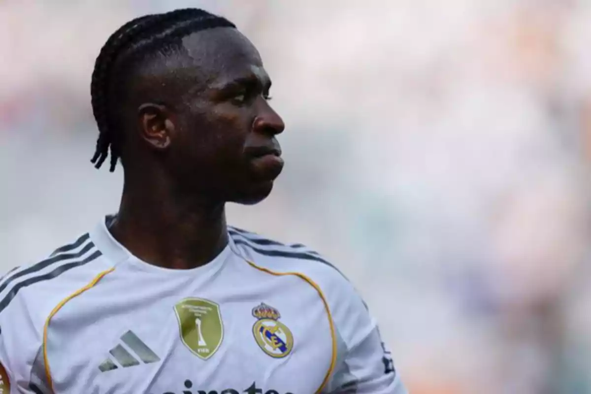 Soccer player in a white Real Madrid uniform looking to the left in a stadium Soccer player in a white Real Madrid uniform looking to the left in a stadium