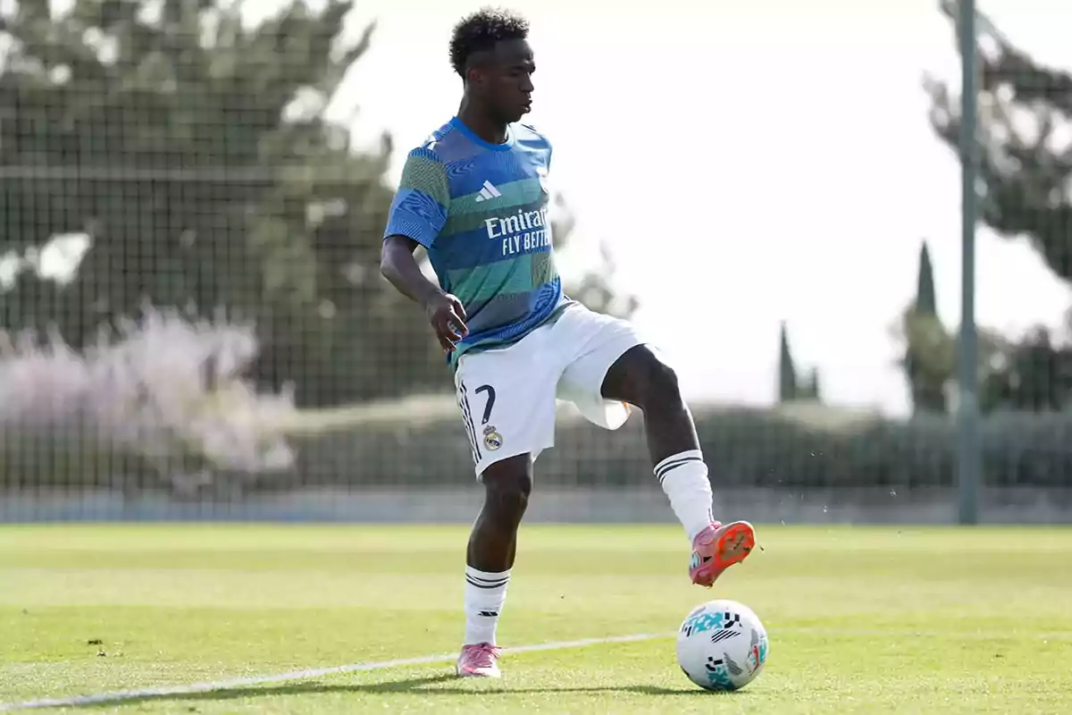 Soccer player wearing Real Madrid training kit controls a ball on the field during a practice session Soccer player wearing Real Madrid training kit controls a ball on the field during a practice session