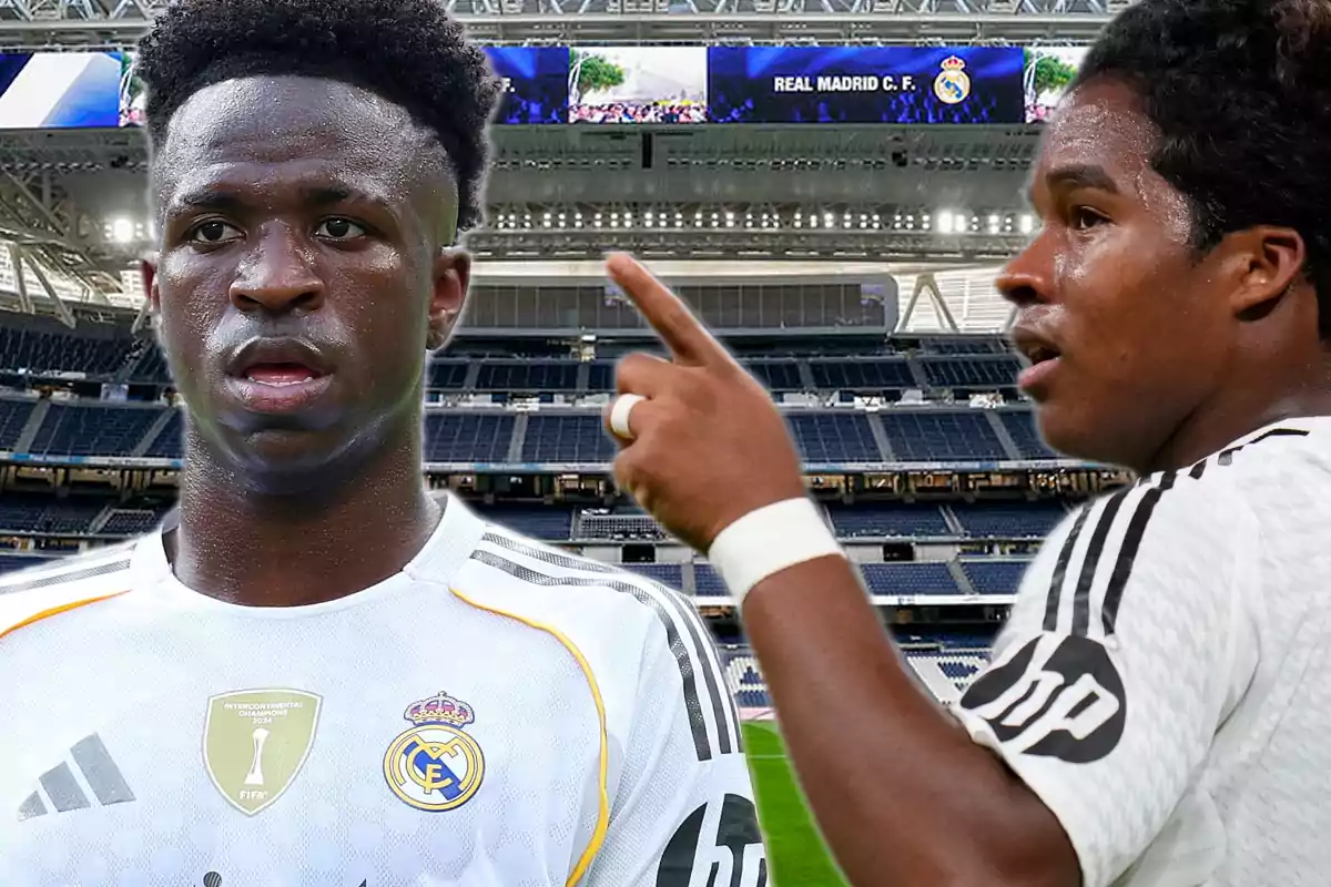 Two players in Real Madrid uniforms at a stadium, one of them pointing with his finger while the other looks ahead.
