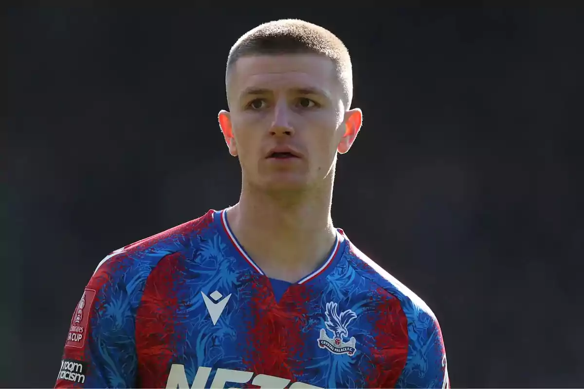 Soccer player wearing a Crystal Palace uniform during a match Soccer player wearing a Crystal Palace uniform during a match