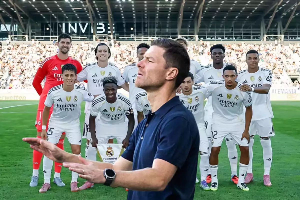 Coach with a thoughtful expression standing in front of a soccer team posing on the field before a match