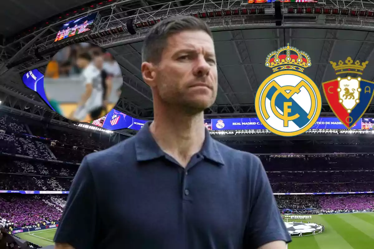 Un hombre de cabello corto y barba recortada está en primer plano dentro de un estadio de fútbol lleno de aficionados, con los escudos de Real Madrid y Osasuna al fondo.