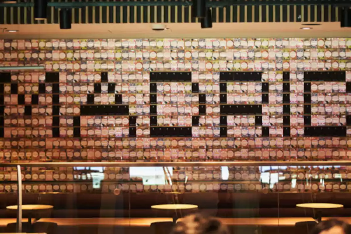 Wall decorated with cans forming the word Madrid inside a modern restaurant Wall decorated with cans forming the word Madrid inside a modern restaurant